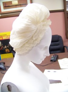 Very fine muslin cap with large caul gathered to a fixed band, ringed with lace.
