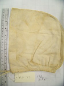 2-piece heavy linen cap, tied under the chin, pleated at the nape.