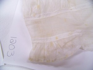 Close-up of center front ruffle, top of headpiece, tight gathering of the caul. 