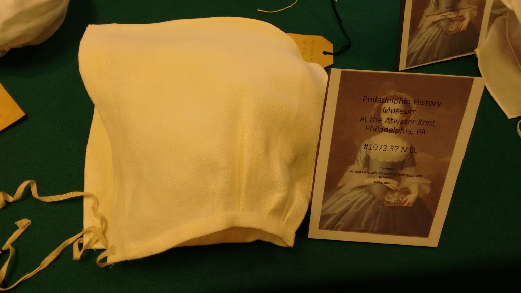 Saines' reproduction of simple 2-piece linen cap with linen tapes under the chin.