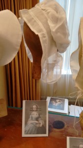 Saines' reproduction on DAR 1203, lappet cap of cotton, shown on hat display.