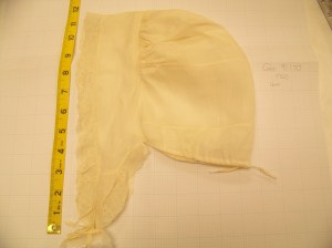 Lappet cap with tape measure showing the height to be about 12 inches. 
