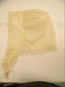 Lappet cap laid flat, showing doubled headpiece and ruffle going all the way around.