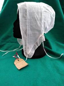 Repro cap shown on black head mount against a green ground. 