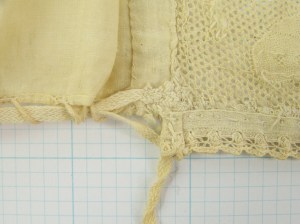 Cap McCord Museum #M980.4.26 photo by author.. Close-up of inside of join of headpiece and caul shows unusual drawstring arrangement.