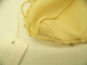 Cap McCord Museum #M980.4.26 photo by author. Close up of midpoint back, inside, of caul, showing construction of drawstring. 
